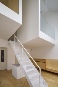 V bytu–ateliéru vznikl koncept zavěšení galerií ve volném dvoupodlažním prostoru. Lehké ocelové schodiště je položeno mezi oběma kubusy.