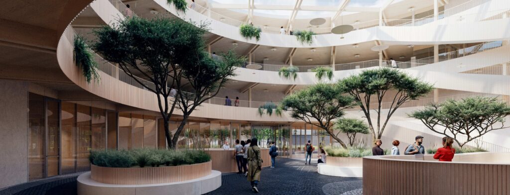 Průchozí atrium se zelení přirozeně propojí budovu s okolním parkem.